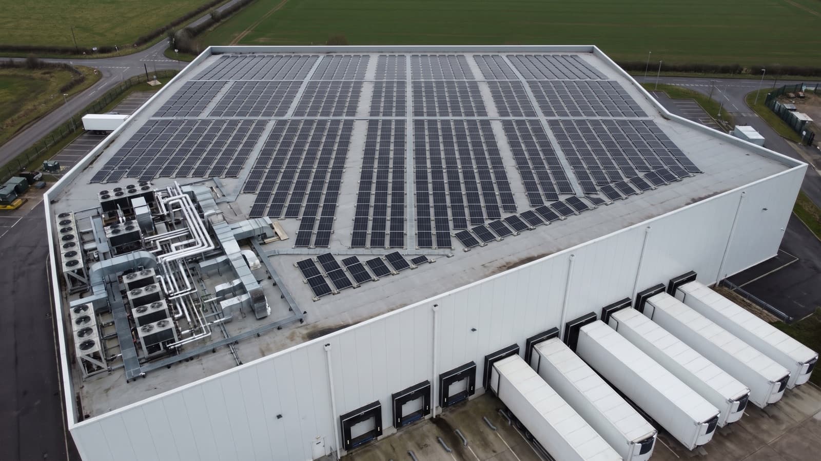 A cold storage depot with a rooftop solar array laid out around its refrigeration plant.